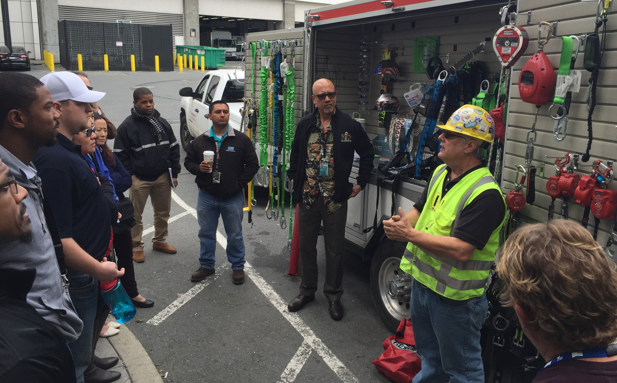 Large group of construction workers receiving on-site safety training